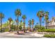 Community entrance featuring tall palm trees, a gated entry, and manicured landscaping for a welcoming arrival at 10109 Jacob Pl # 203, Las Vegas, NV 89144