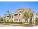 Charming condo building featuring a tan facade, well-maintained landscaping, and convenient stair access at 10109 Jacob Pl # 203, Las Vegas, NV 89144