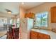 This kitchen offers a functional layout, with a refrigerator, wood cabinets, and a dining area, perfect for everyday meals at 10109 Jacob Pl # 203, Las Vegas, NV 89144