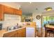The open kitchen showcases a breakfast bar, stainless steel sink, and access to the outdoor patio at 10109 Jacob Pl # 203, Las Vegas, NV 89144