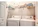 Practical laundry room with side-by-side washer and dryer, plus storage shelves at 10109 Jacob Pl # 203, Las Vegas, NV 89144