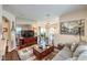 Cozy living room features hardwood floors, a comfortable sofa, large TV, and access to dining and kitchen at 10109 Jacob Pl # 203, Las Vegas, NV 89144