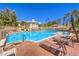 Community pool features sparkling water, lounge chairs, and meticulously maintained landscaping, perfect for relaxation at 10109 Jacob Pl # 203, Las Vegas, NV 89144