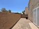 A small backyard with gravel and a block wall, perfect for low-maintenance outdoor space at 10230 Viterbo St, Las Vegas, NV 89183