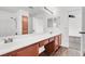 Bathroom vanity features dual sinks, wood cabinets and walk in shower at 10230 Viterbo St, Las Vegas, NV 89183