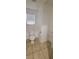 Bathroom features a toilet and a pedestal sink, with tile flooring and a window at 10230 Viterbo St, Las Vegas, NV 89183
