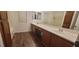Bathroom featuring double sink with countertop and cabinets, window, and a shower with bathtub at 10230 Viterbo St, Las Vegas, NV 89183