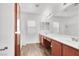 Bathroom features wood-look floors, cherry cabinets and dual sinks at 10230 Viterbo St, Las Vegas, NV 89183