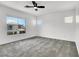 Bright bedroom features neutral carpet, ceiling fan, and multiple windows at 10230 Viterbo St, Las Vegas, NV 89183