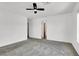 Spacious bedroom with neutral carpet and fan, leading to hallway at 10230 Viterbo St, Las Vegas, NV 89183