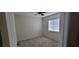 Carpeted bedroom with a ceiling fan, a window, and neutral paint at 10230 Viterbo St, Las Vegas, NV 89183