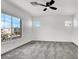 Bedroom with carpet, fan and view of street with other homes at 10230 Viterbo St, Las Vegas, NV 89183