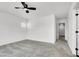 Large carpeted bedroom with ceiling fan and view of hallway at 10230 Viterbo St, Las Vegas, NV 89183