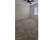 Carpeted bedroom with a ceiling fan, a window, and neutral paint at 10230 Viterbo St, Las Vegas, NV 89183