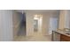 Bright entryway adjacent to the kitchen offers access to the stairway and downstairs powder room at 10230 Viterbo St, Las Vegas, NV 89183