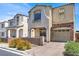 Street view of the two-story home featuring stucco siding, shutters, and an attached one-car garage at 10230 Viterbo St, Las Vegas, NV 89183