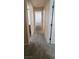 Hallway featuring carpeted flooring with multiple doorways and views of other rooms at 10230 Viterbo St, Las Vegas, NV 89183