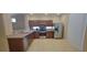 Well-lit kitchen featuring stainless steel appliances and warm wooden cabinetry at 10230 Viterbo St, Las Vegas, NV 89183