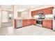 Bright kitchen with stainless steel appliances, granite countertops, and tile flooring at 10230 Viterbo St, Las Vegas, NV 89183