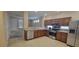 Well-lit kitchen featuring stainless steel appliances, wooden cabinets, and a breakfast bar at 10230 Viterbo St, Las Vegas, NV 89183