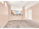 Spacious living room with gray carpet and view into the kitchen at 10230 Viterbo St, Las Vegas, NV 89183
