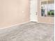Unfurnished living room featuring a new carpet, neutral paint and ample natural light at 10230 Viterbo St, Las Vegas, NV 89183