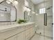 Modern bathroom features a double vanity, marble countertop, and glass-enclosed shower at 10277 Roma Madre Ave, Las Vegas, NV 89135