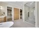 Open bathroom featuring dual walk-in closets and glass shower at 10277 Roma Madre Ave, Las Vegas, NV 89135