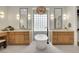Elegant bathroom featuring dual vanities, a freestanding tub, and stylish lighting fixtures at 10277 Roma Madre Ave, Las Vegas, NV 89135