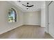 Bedroom with a large window, sleek ceiling fan, and an airy, light-filled ambiance at 10277 Roma Madre Ave, Las Vegas, NV 89135