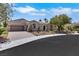 Attractive single-story home with a three-car garage, desert landscaping, and a paved driveway at 10277 Roma Madre Ave, Las Vegas, NV 89135