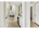 Hallway with white cabinets and a wine fridge, leading to a living area with stylish decor at 10277 Roma Madre Ave, Las Vegas, NV 89135