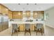Bright kitchen boasts custom cabinets, stainless steel appliances, and an oversized island with pendant lighting at 10277 Roma Madre Ave, Las Vegas, NV 89135