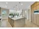Spacious kitchen with a central island, stainless steel appliances, and custom wood cabinetry at 10277 Roma Madre Ave, Las Vegas, NV 89135
