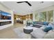Cozy living room flowing into a modern kitchen with stainless steel appliances and a central island at 10277 Roma Madre Ave, Las Vegas, NV 89135