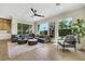 Cozy living room with a corner sectional, ceiling fan, and lots of natural light at 10277 Roma Madre Ave, Las Vegas, NV 89135