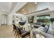 Open-concept living space with contemporary furniture, hardwood floors, and large windows offering backyard views and ample seating at 10277 Roma Madre Ave, Las Vegas, NV 89135