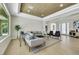 Bright and airy living room with stylish decor features modern furniture, light hardwood floors, and a textured accent wall at 10277 Roma Madre Ave, Las Vegas, NV 89135