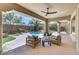 Relaxing covered patio with comfortable seating overlooking the pool and backyard at 10277 Roma Madre Ave, Las Vegas, NV 89135