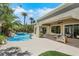 Inviting backyard pool with mature landscaping and covered patio sitting area at 10277 Roma Madre Ave, Las Vegas, NV 89135