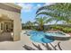 This backyard features a pool with integrated spa, lush landscaping, and a covered patio for luxurious outdoor living at 10277 Roma Madre Ave, Las Vegas, NV 89135