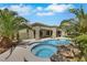Backyard view showcases the pool and spa surrounded by palm trees with ample space for lounging and outdoor entertainment at 10277 Roma Madre Ave, Las Vegas, NV 89135