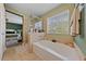 Bright bathroom featuring a separate shower and tub with stone surround at 10440 Bay Ginger Ln, Las Vegas, NV 89135