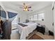 Well-lit bedroom with carpet flooring, ceiling fan, and a window providing natural light at 10440 Bay Ginger Ln, Las Vegas, NV 89135