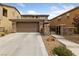 Stylish two-story home features a two-car garage, desert landscaping, and decorative stone accents on the facade at 10440 Bay Ginger Ln, Las Vegas, NV 89135