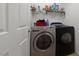 Laundry room with modern washer and dryer, and shelving for storage at 10440 Bay Ginger Ln, Las Vegas, NV 89135