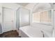 Bright bathroom features a soaking tub, a shower, and natural light from the window at 10458 Gabaldon St, Las Vegas, NV 89141