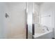 Shower and soaking tub combo with white tiles, and natural light coming from the window at 10458 Gabaldon St, Las Vegas, NV 89141