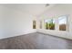 Spacious bedroom with vaulted ceilings, large windows, and modern flooring at 10458 Gabaldon St, Las Vegas, NV 89141