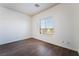 A well-lit bedroom with wood-look floors, base-trim and a window with a view at 10458 Gabaldon St, Las Vegas, NV 89141